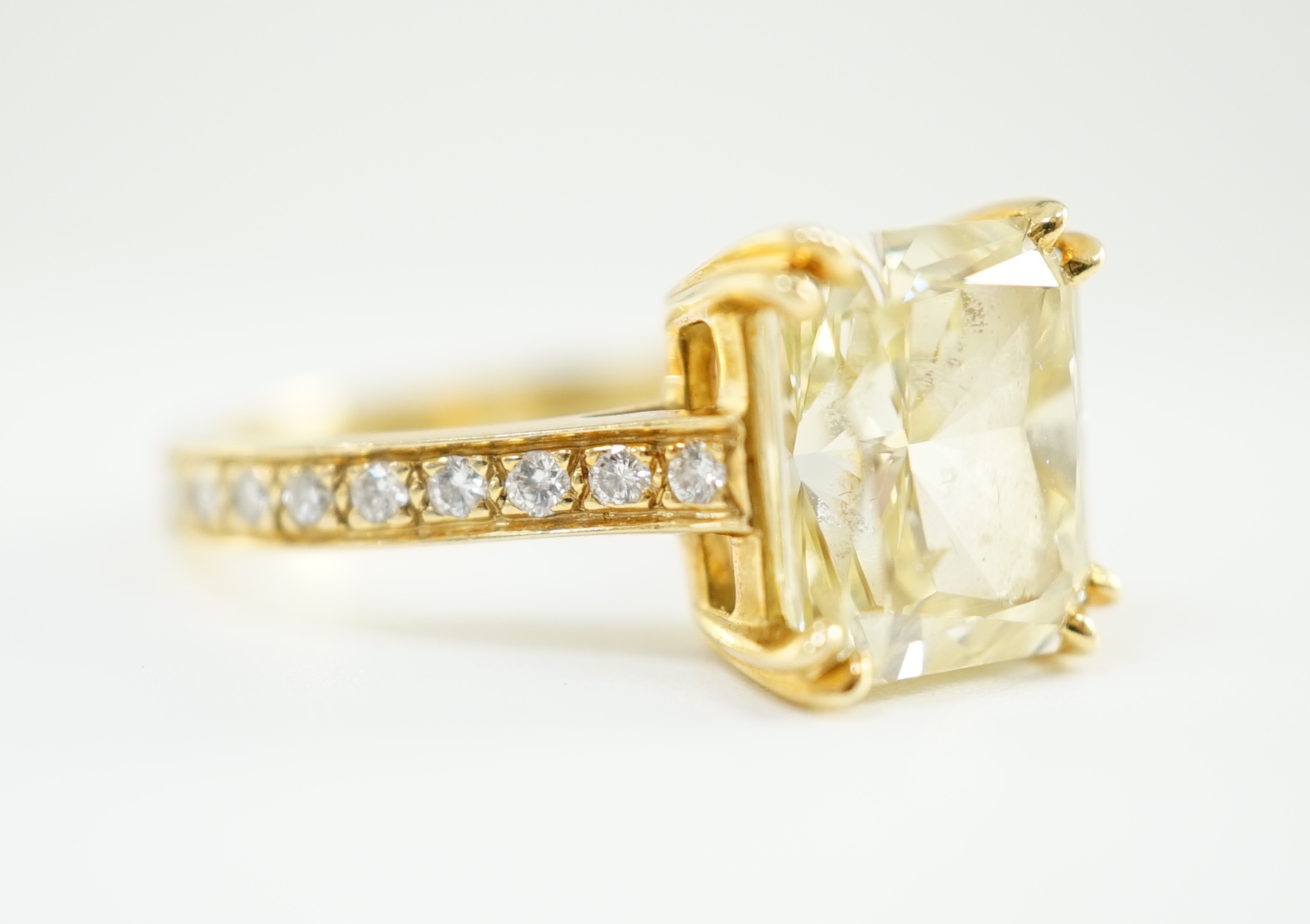 An impressive modern 18ct gold and cut cornered rectangular modified brilliant cut natural fancy yellow single stone diamond ring